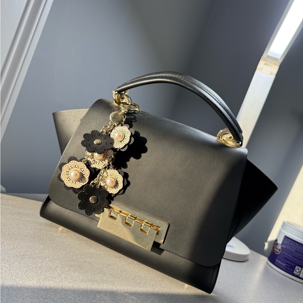Black and Gold Satchel with Floral Embellishment and Structured Shape